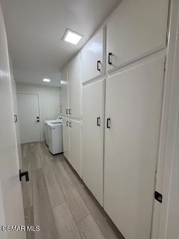 a view of a hallway with white walls