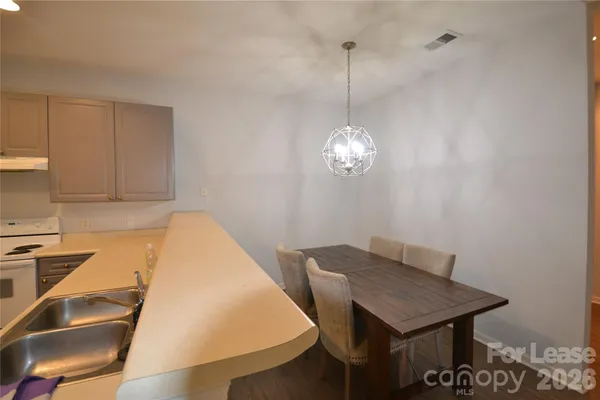 a view of a dining room and chandelier fan