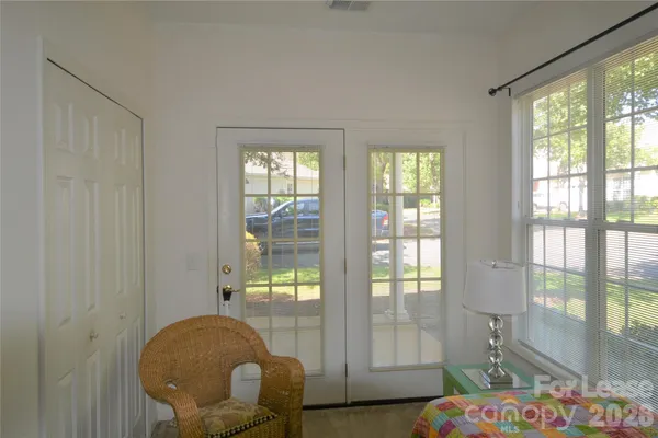 a living room with furniture and a floor to ceiling window