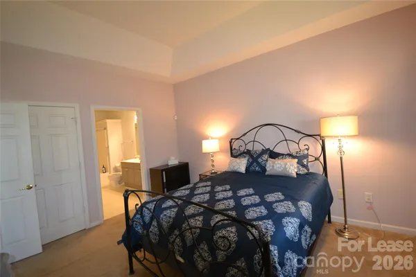 a bedroom with a bed and a mirror
