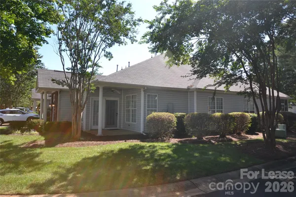 a house that has a tree in front of it