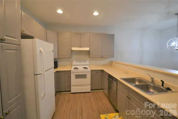 a kitchen with a stove a sink and a refrigerator