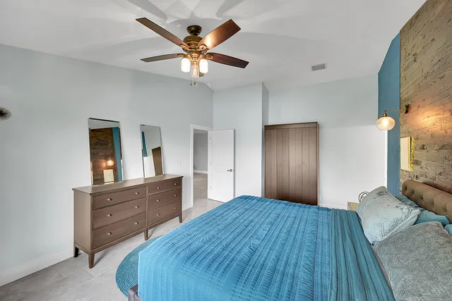 a bedroom with a bed and a dresser