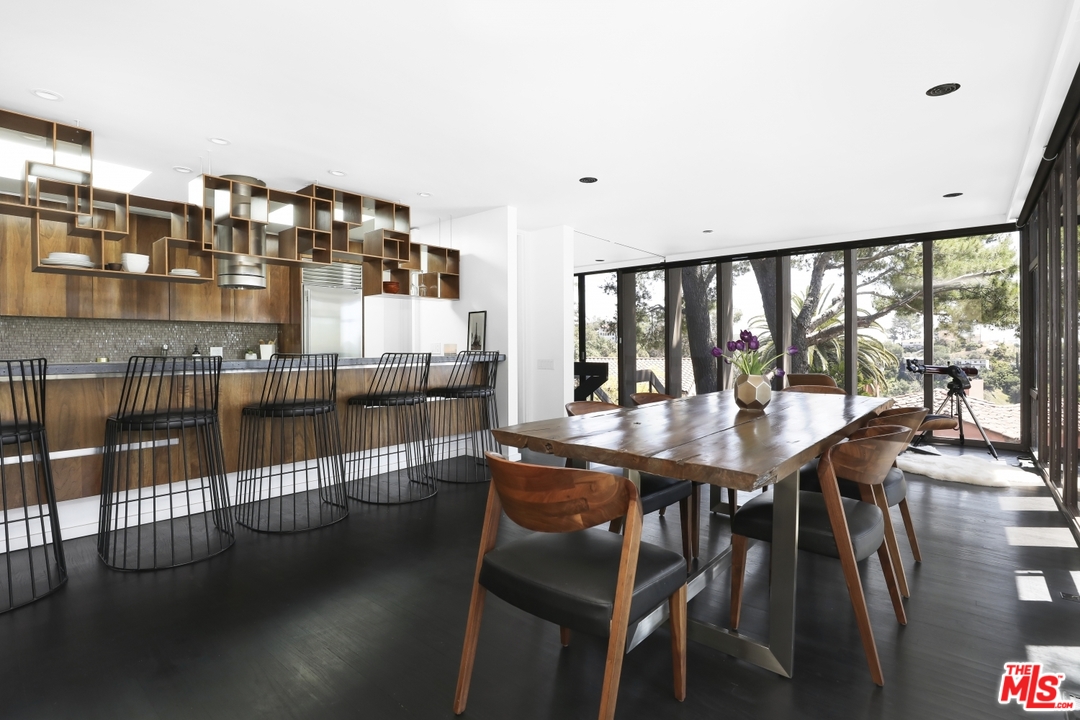 2867 Belden Drive Los Angeles, CA 90068 - Photo 20 of 54 a dining hall with stainless steel appliances granite countertop a dining table and chairs with wooden floor