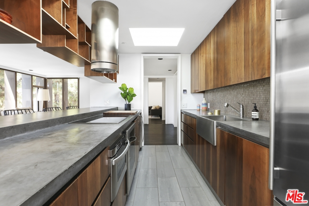 2867 Belden Drive Los Angeles, CA 90068 - Photo 26 of 54 a kitchen with stainless steel appliances granite countertop a sink a stove and a wooden floors