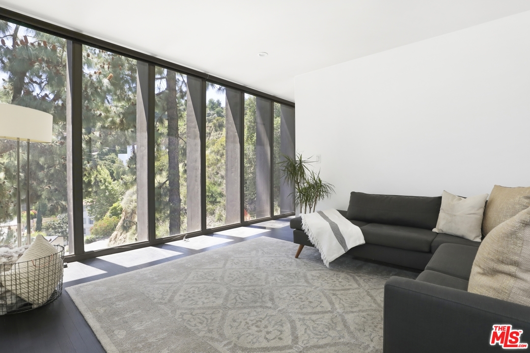 2867 Belden Drive Los Angeles, CA 90068 - Photo 28 of 54 a living room with furniture and a floor to ceiling window