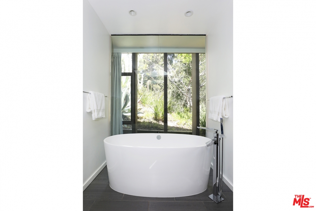 2867 Belden Drive Los Angeles, CA 90068 - Photo 35 of 54 a white bath tub sitting in a bathroom with a sink