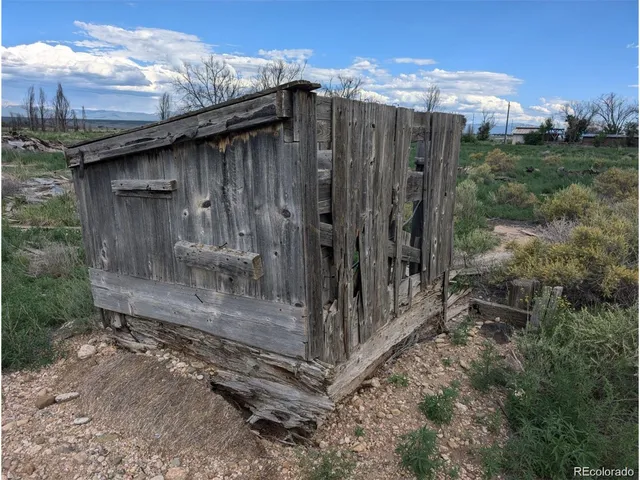 a view of a wooden house with a small cabin