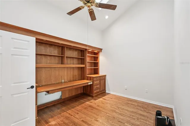 a view of swimming pool with lawn chairs and plants