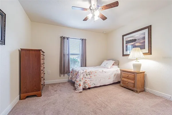 a spacious bedroom with a bed and a chandelier