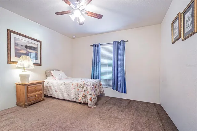 a spacious bedroom with a bed and a chandelier