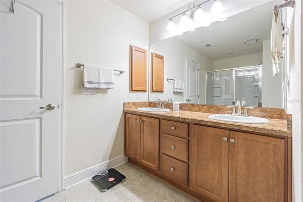 a bathroom with a double vanity sink and mirror