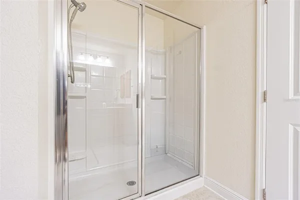 a bathroom with a glass shower door
