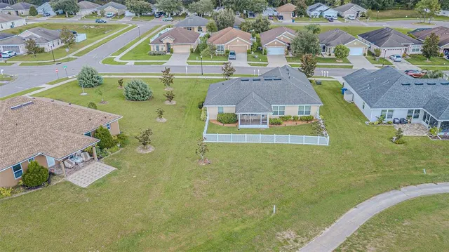 an aerial view of residential houses with outdoor space and swimming pool