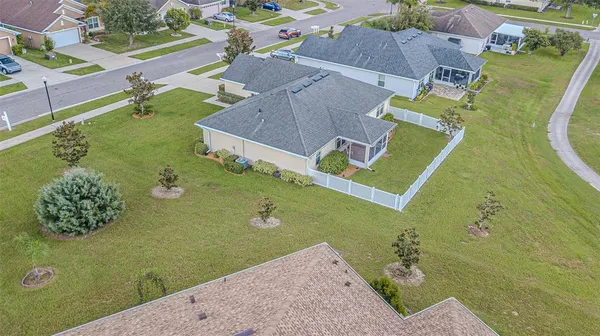 an aerial view of a house with a yard