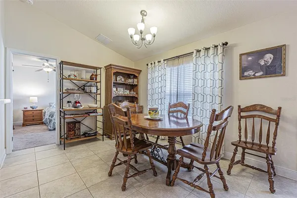 a view of a dining room with furniture and chandelier