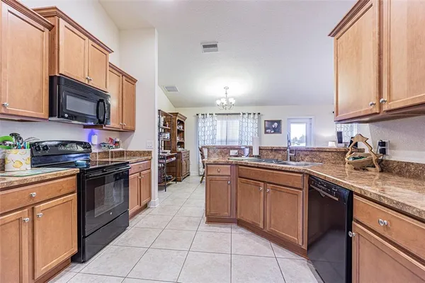 a kitchen with stainless steel appliances granite countertop a sink and dishwasher a stove top oven with wooden floor
