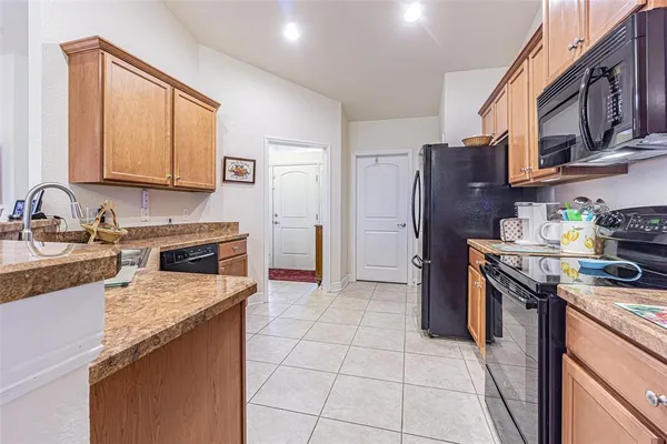 a kitchen with a stove a sink and a refrigerator