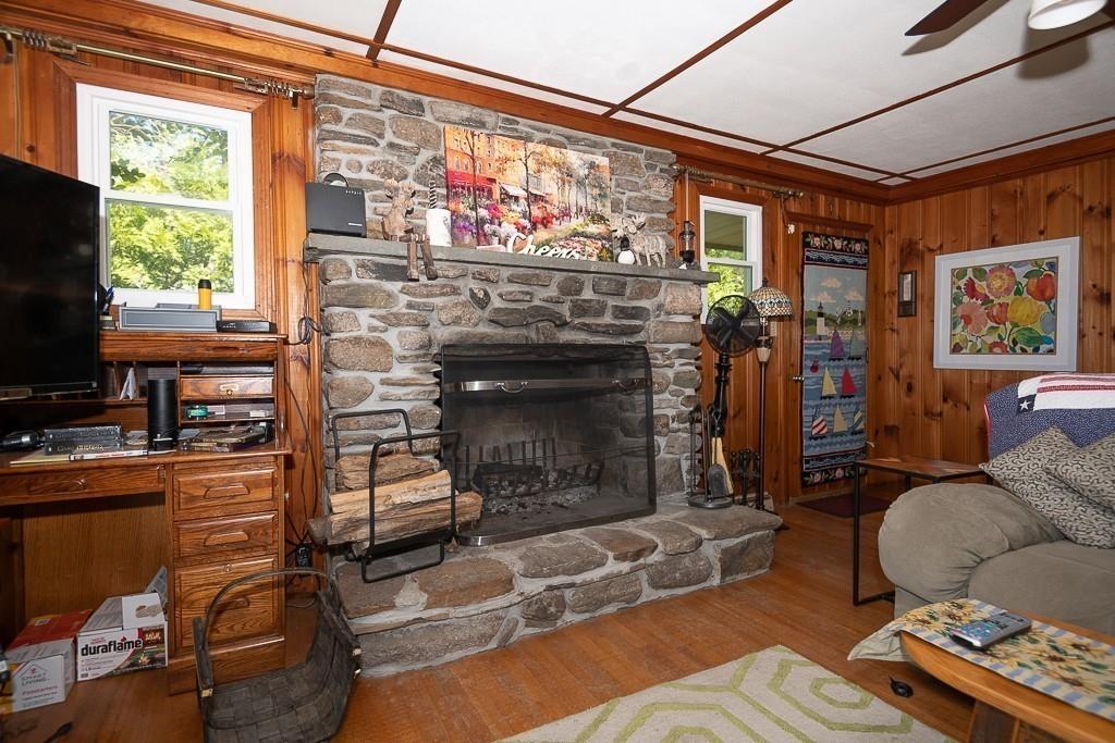 3 Lakeview Road Webster, MA 01570 - Photo 14 of 40 a living room with furniture a flat screen tv and a fireplace