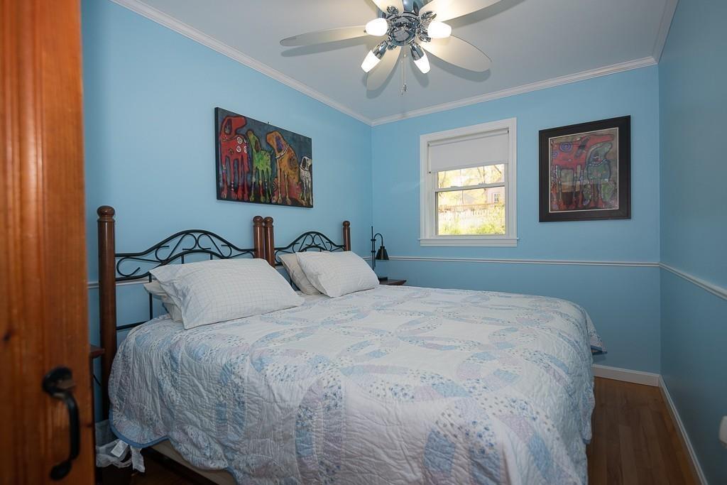 3 Lakeview Road Webster, MA 01570 - Photo 20 of 40 a bedroom with a bed and a chandelier