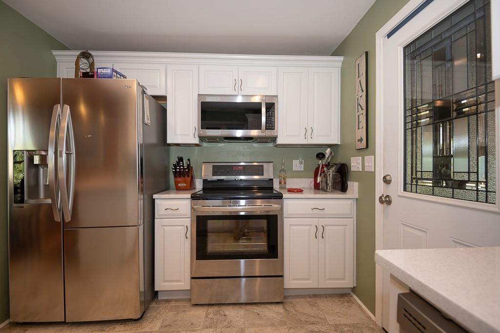 3 Lakeview Road Webster, MA 01570 - Photo 7 of 40 a kitchen with stainless steel appliances white cabinets and a refrigerator