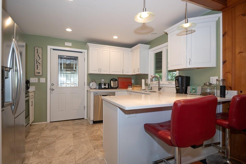3 Lakeview Road Webster, MA 01570 - Photo 8 of 40 a kitchen with stainless steel appliances granite countertop a sink refrigerator stove and microwave