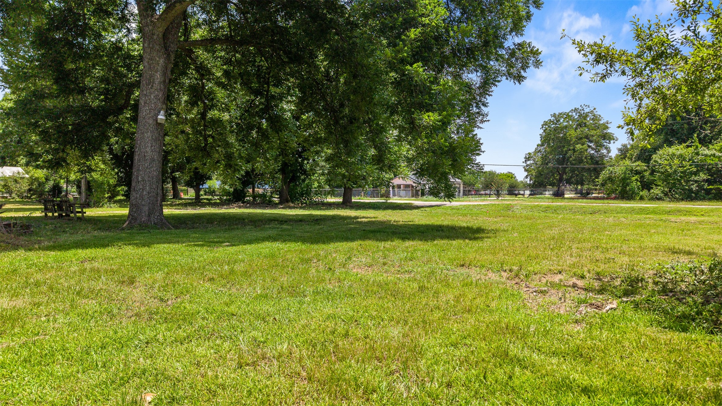 14835 Lillja Road Houston, TX 77060 - Photo 11 of 16 Looking toward Lillja Road, this expansive property offers a beautiful blend of open green space and natural shade, creating an inviting setting with plenty of room to bring your vision to life.