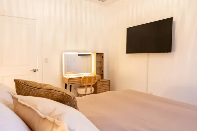 a bedroom with a bed and flat screen tv