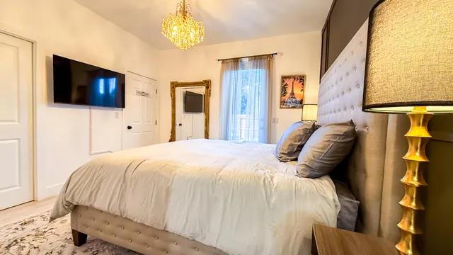 a bedroom with a bed and a television