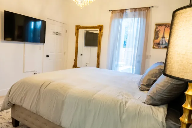 a bedroom with a bed and a flat screen tv