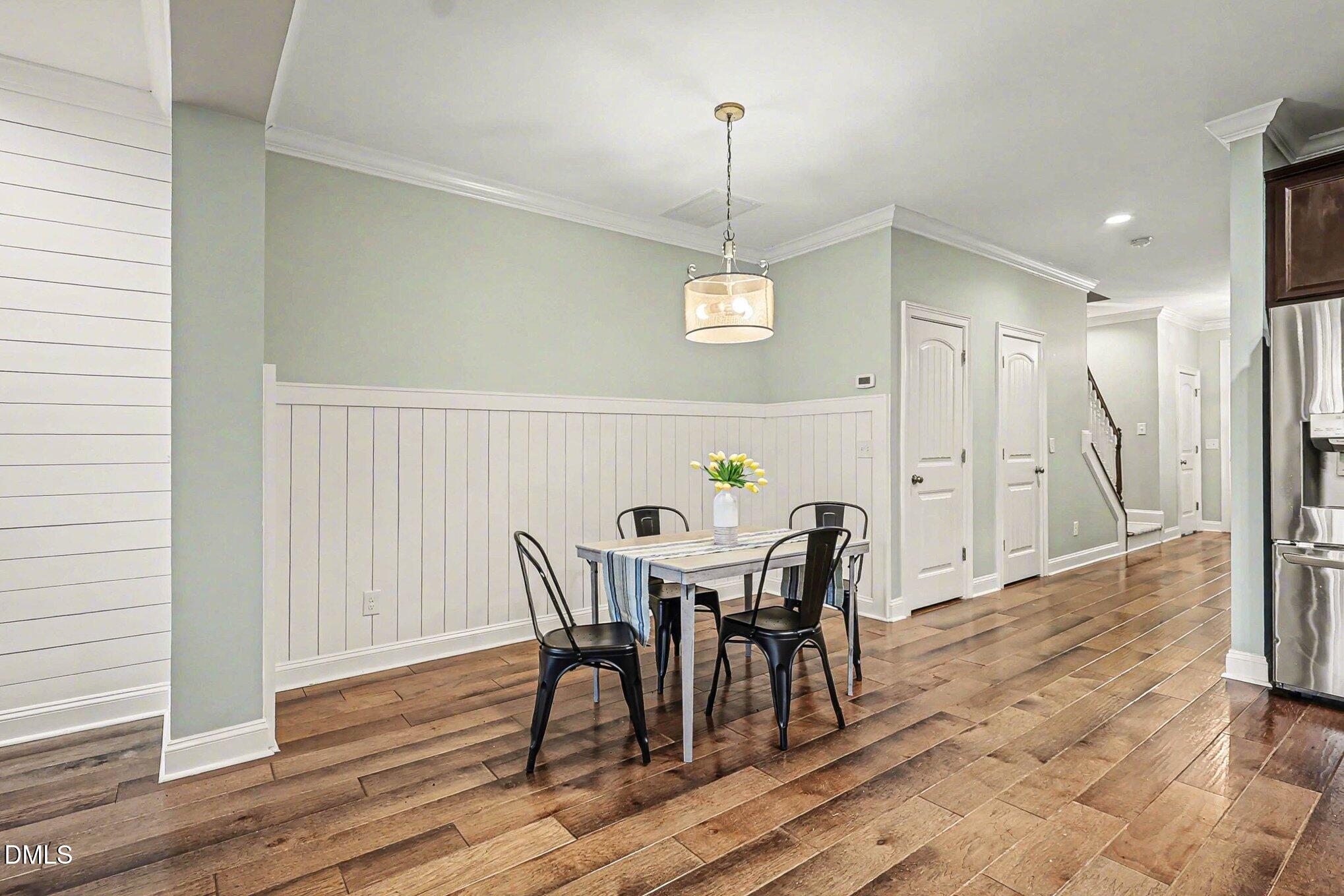653 Fallon Grove Way Raleigh, NC 27608 - Photo 5 of 38 a view of a dining room with furniture and wooden floor