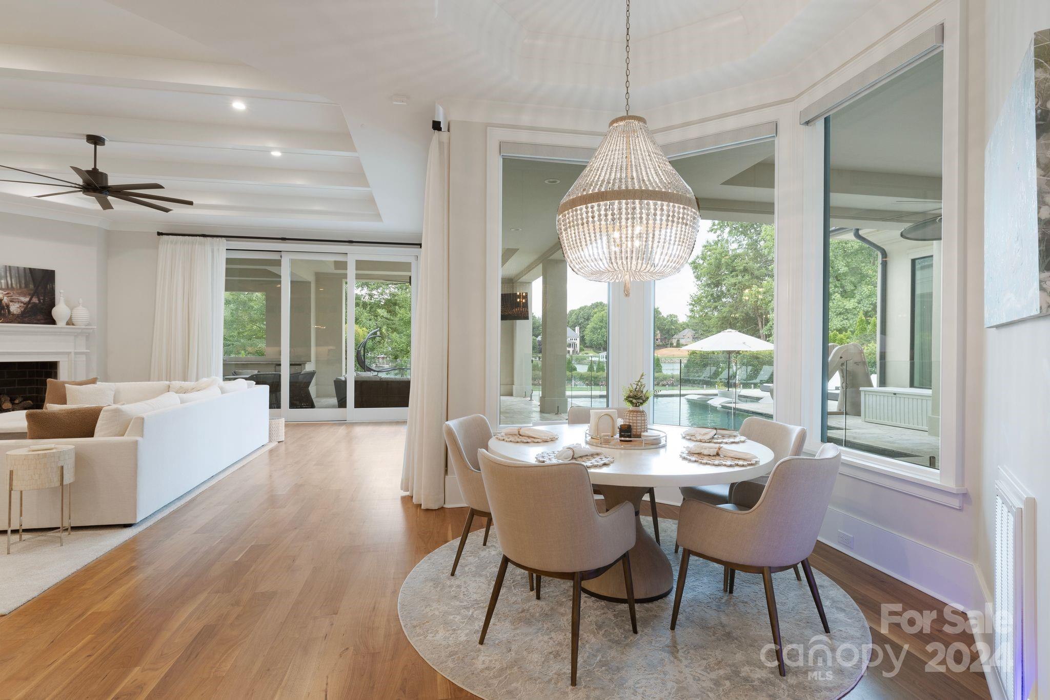 19004 Double Eagle Drive Cornelius, NC 28031 - Photo 28 of 48 a dining room with furniture a chandelier and wooden floor