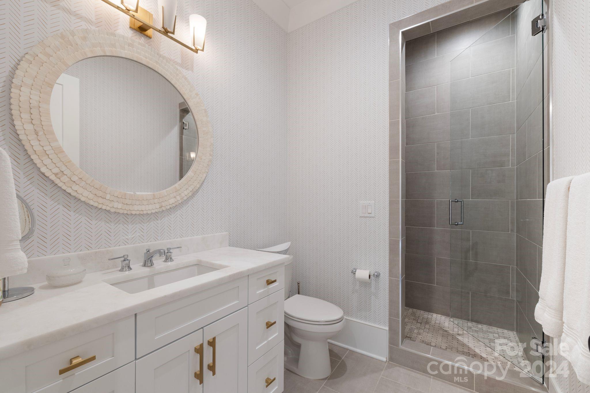 19004 Double Eagle Drive Cornelius, NC 28031 - Photo 41 of 48 a bathroom with a sink a toilet and shower