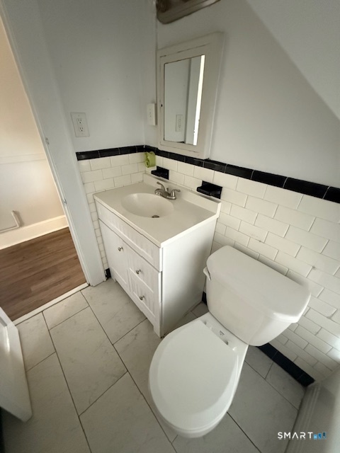41 Alfred Street Bridgeport, CT 06605 - Photo 8 of 11 a bathroom with a toilet sink and mirror