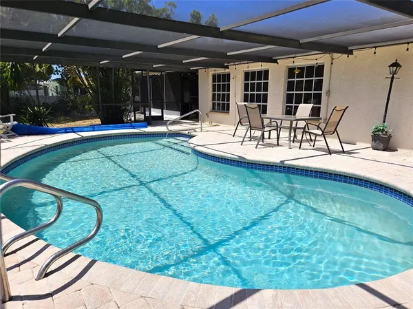 a swimming pool with outdoor seating and yard