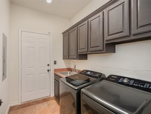 a kitchen with a sink cabinets and appliances