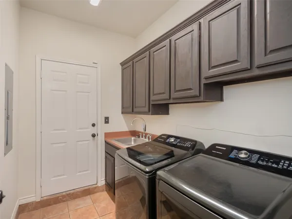 a kitchen with a sink cabinets and appliances