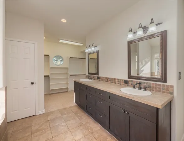 a bathroom with a double vanity sink mirror and a