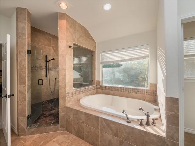 a bathroom with a bathtub and a shower