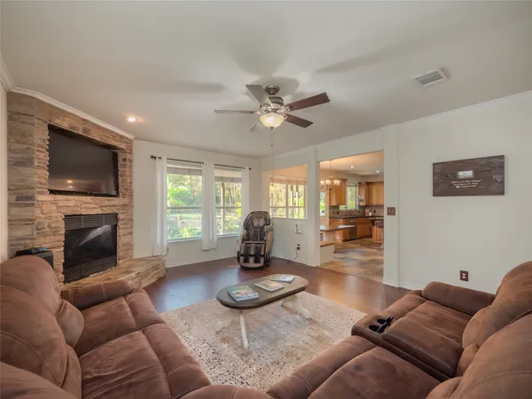 a living room with furniture a fireplace and a flat screen tv