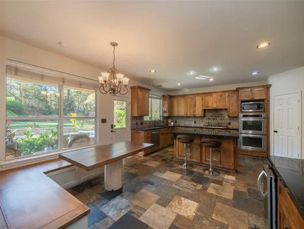 a kitchen with a counter space a sink and appliances