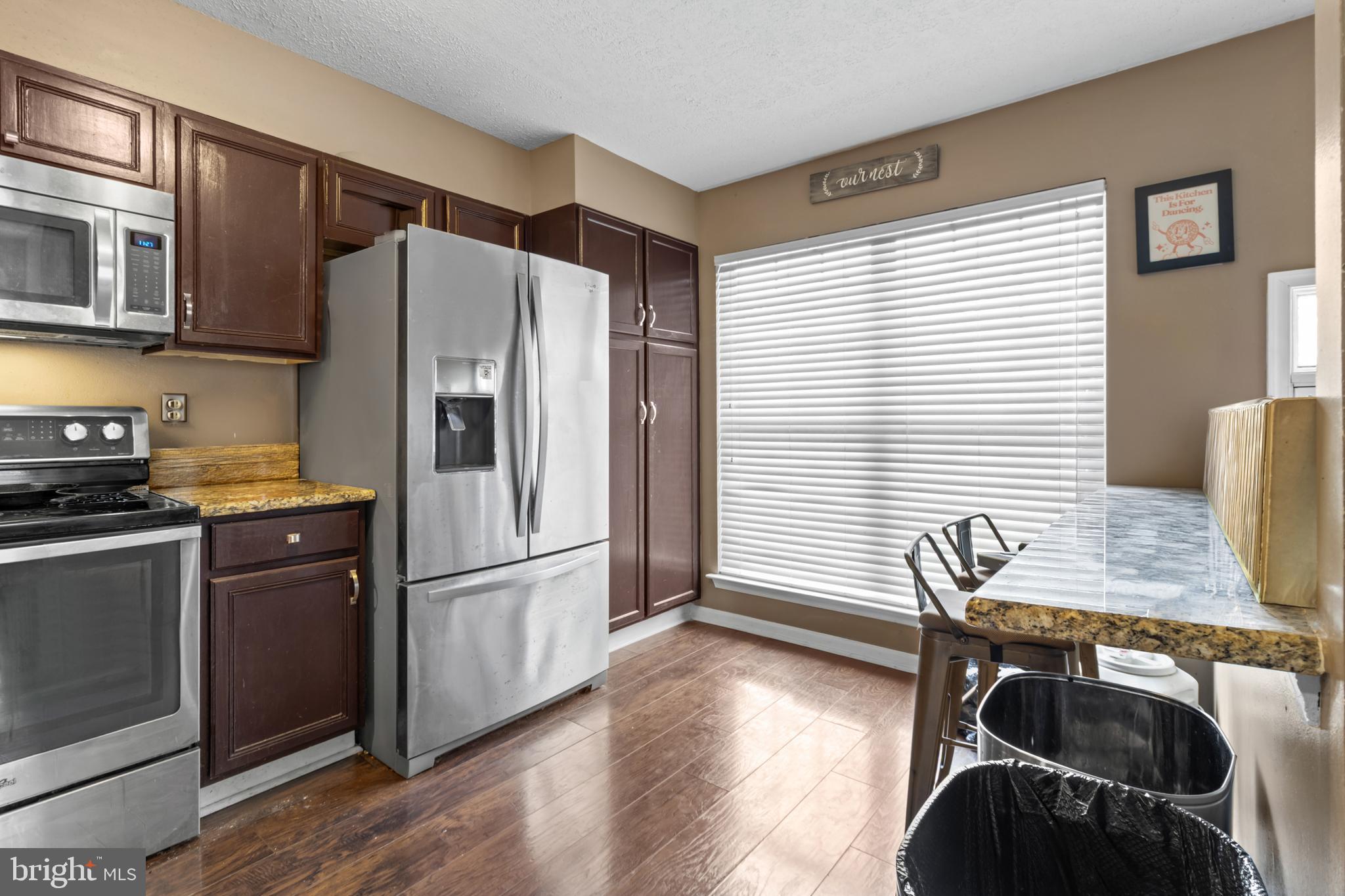 115 Balmoral Way Newark, DE 19702 - Photo 10 of 31 a kitchen with stainless steel appliances granite countertop a refrigerator a stove and a wooden floors