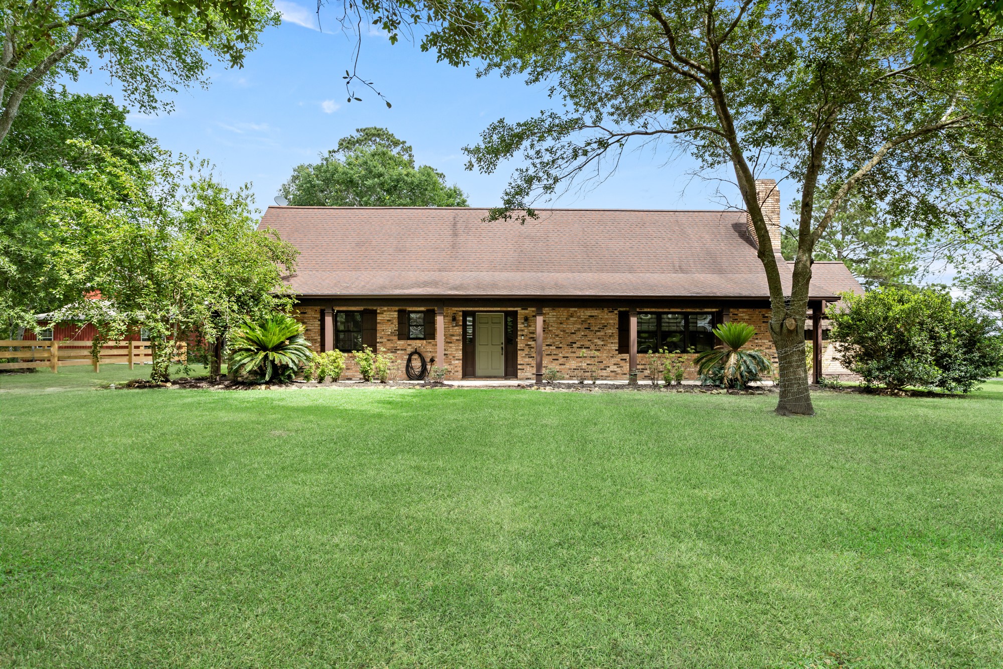1747 Farm To Market Road 365 Nome, TX 77629 - Photo 11 of 24 a front view of a house with a garden