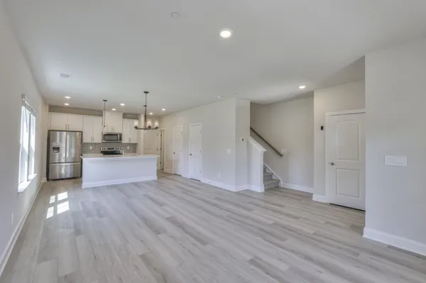 a view of kitchen with wooden floor and a window