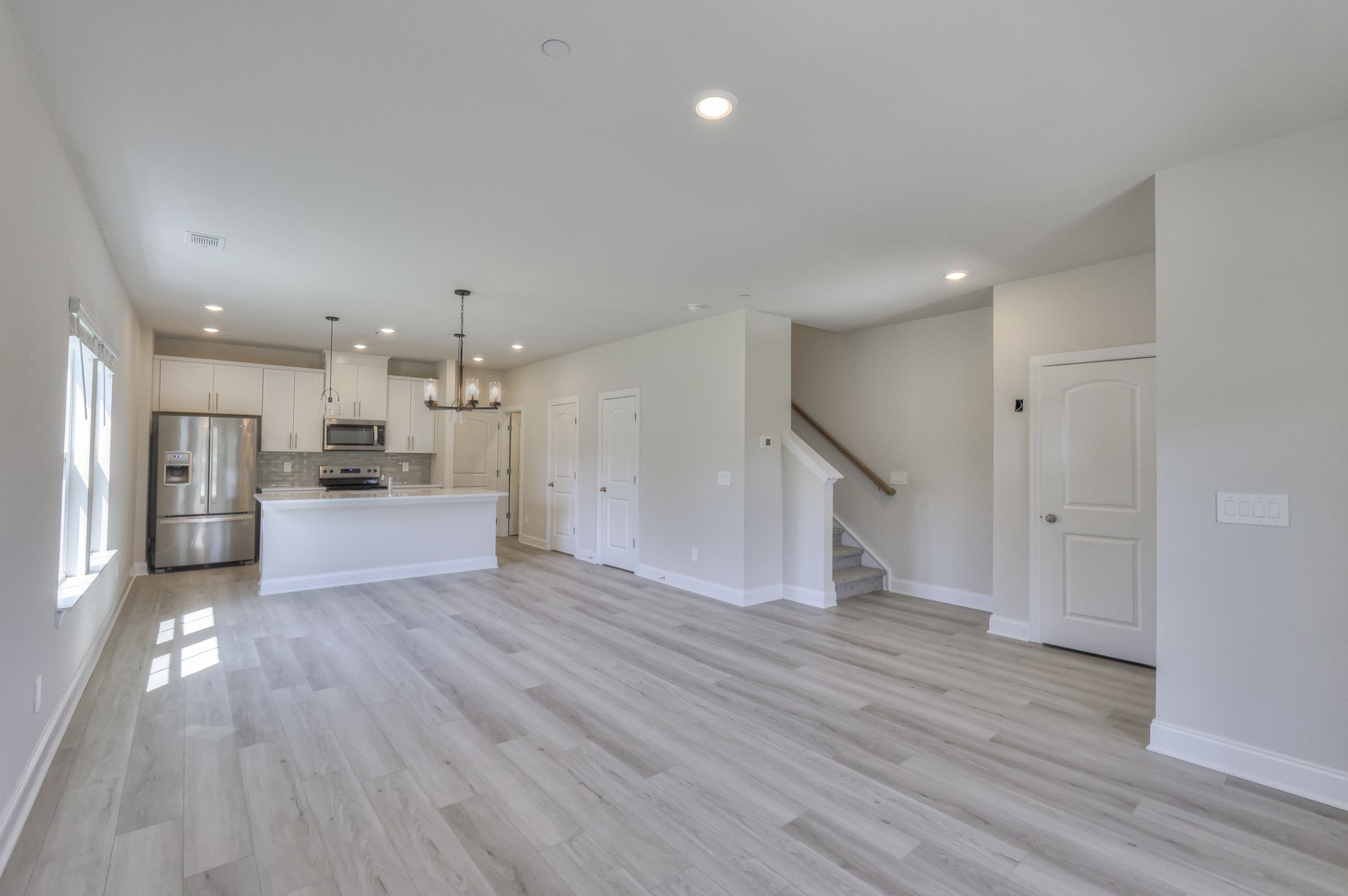 a view of kitchen with wooden floor and a window