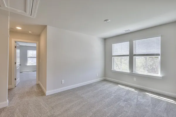 an empty room with windows and closet