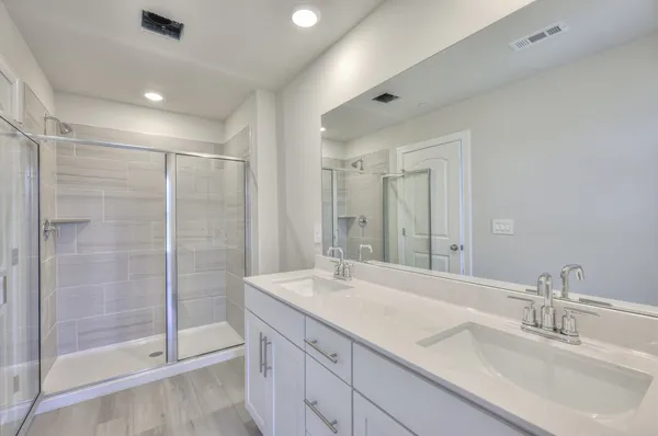 a bathroom with a shower sink and mirror