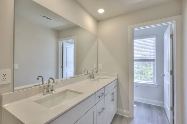 a bathroom with a sink vanity and a mirror