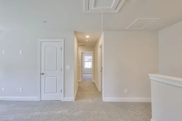 an empty room with cabinet and mirrors