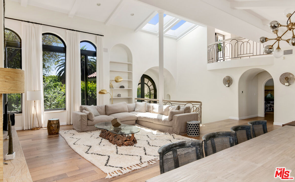 28899 Cliffside Drive Malibu, CA 90265 - Photo 12 of 53 a living room with couches a large mirror with wooden floor and windows